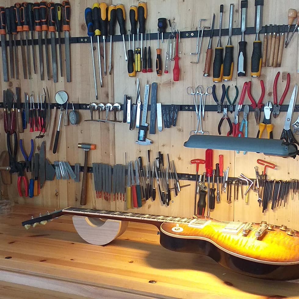 Gibson Les Paul electric guitar on a luthiers' workbench for a setup.